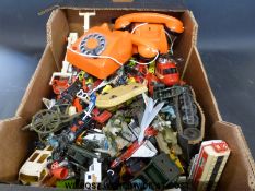 A collection of diecast model vehicles and two telephones