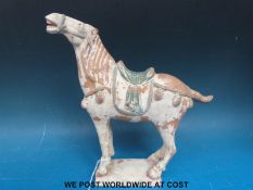 Chinese Tang dynasty style painted terracotta model of a horse (23cm tall)
