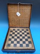 A Chinese carved wooden chess set inside a box