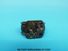 A Japanese bronze dagger fitting depicting figures