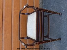 A c1900 piano stool with tapered legs and decorative inlay on spade feet