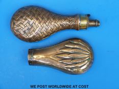 Two copper powder flasks with embossed decoration,