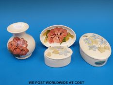 A small oval Moorcroft lidded pot decorated with blue anemones (3x14cm) together with a smaller