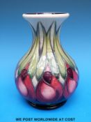 A Moorcroft pedestal vase decorated in the Indigo pattern (16cm tall)