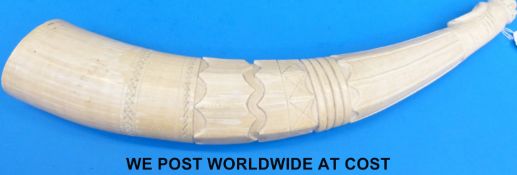 A large oliphant or ivory horn carved with three styles of carving,