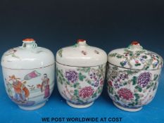 A pair of Chinese lidded jars with chrysanthemum decoration and another depicting a figural scene