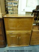 A light oak or elm fall flap bureau in the manner of Ercol (W80 x D46 x H109cm)