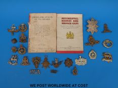 A collection of WWI and WWII military cap badges etc.