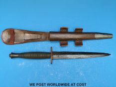 A Fairbairn-Sykes WWII fighting knife in leather scabbard.