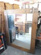A large rustic style mirror with bevelled edge (overall size 117x147cm)
