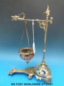 A brass hanging incense burner with griffin or phoenix head decoration and mask finial