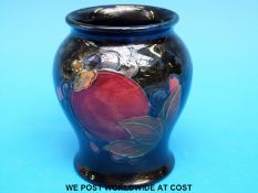 A Moorcroft squat vase decorated in Pomegranate pattern (8cm tall)