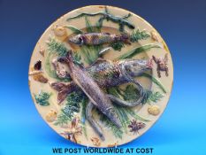 A Portugese palissy ware charger decorated with pike, carp, eels, crustaceans,