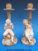 A pair of c1880's Royal Worcester blush ivory Kate Greenaway figural candlesticks in the form of a