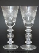 Eight large wine goblets/glasses with geometric cut decoration raised on triple knopped stems and