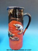 A Japanese Sumida Gawa jug decorated with two figures in relief (21cm tall)