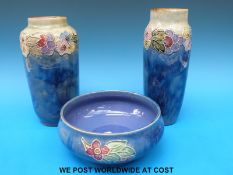Two Royal Doulton stoneware cylindrical vases (23cm tall) and matching bowl (diameter 16cm),