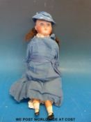 A bisque headed doll with fixed blue eyes, open mouth & brown hair,