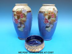 A pair of Royal Doulton vases decorated with fruit on a blue ground,