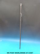 A carved Anglo Indian stick with white metal top