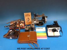 A boxed Octopus microscope, a miniature Singer sewing machine, Polaroid land camera,