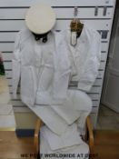 A quantity of Royal Naval tropical uniform with cap, includes shirts, shorts,