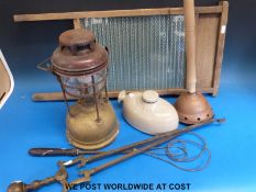 A quantity of kitchenware including a pine and glass washboard, Tilley lamp, carpet beater,
