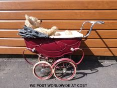 Sliver Cross dolls pram in burgundy and cream together with a vintage bear.