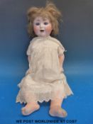 A bisque headed doll with blue closing eyes, open mouth and blonde hair,