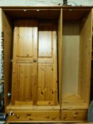 A pine three door wardrobe with drawers below (W132 x D51 x H182cm)