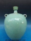 A green ground Chinese twin handled vase (24cm tall)