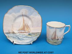 A Royal Crown Derby coffee can and saucer hand decorated with scenes of sailing ships under full
