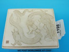 A Chinese carved ivory box featuring a dragon to the lid with seal mark to the bottom left (10.