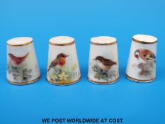 Four Royal Worcester thimbles hand decorated with birds,