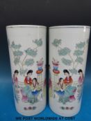 A pair of Chinese cylindrical vases with court figure decoration (28cm tall)