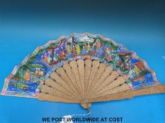 A Chinese fan made up of carved sandalwood and painted paper decorated with court figures with