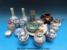 A quantity of blue and white Chinese miniature lidded rice bowls, two small vases, a scent bottle,