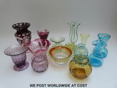 Fourteen pieces of coloured glassware to include flush overlaid cut glass vases,