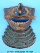 A Japanese Edo period Mempo with blue cords.