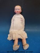 A bisque headed doll with fixed dark blue eyes & open mouth,