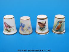 Four signed Royal Worcester thimbles, three hand decorated with birds and one with campanula,