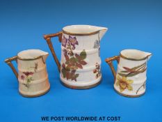 Two Royal Worcester barrel shaped jugs hand painted with flowers (6cm tall) together with another