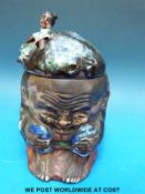 A Japanese Sumida Gawa tobacco jar formed as a head with a figure in relief to the lid (15cm tall)