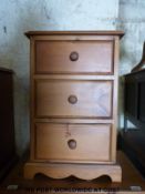 A pair of pine bedside chests of three drawers (W43 x D32 x H65cm)