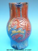 An Elton pottery jug with relief decoration of a grotesque fish (20cm tall)