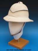 A military pith helmet with leather strap and sweat band