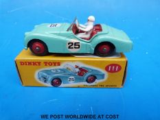 Dinky Toys diecast model Triumph TR2 Sports III with turquoise body and red hubs and interior,
