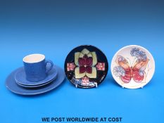 A small Moorcroft pin dish decorated with a butterfly and another with an abstract violet design