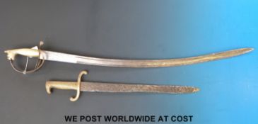 A brass-handled carved sword and a brass-handled bayonet