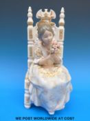 A Lladro figure of a lady with a bouquet seated